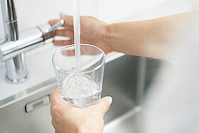 Woman filling glass of water