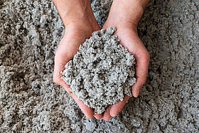 Close shot of eco friendly cellulose insulation filling held in